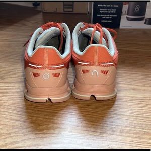 on cloud orange tennis shoes. in great condition!
